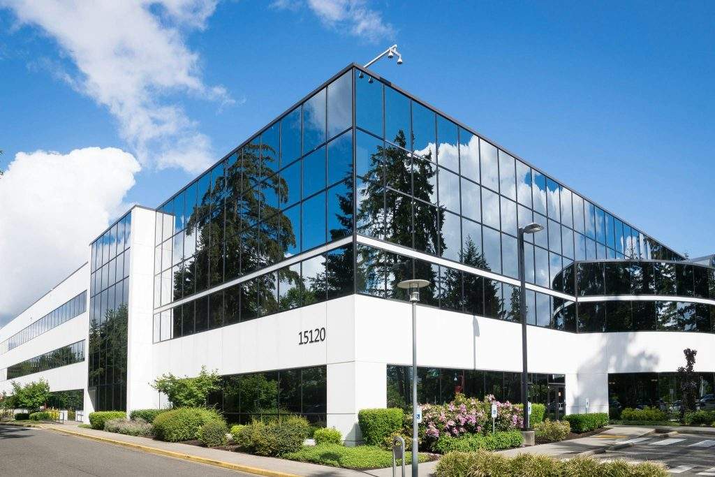 Una imagen de un edificio de una empresa lleno de espejos.