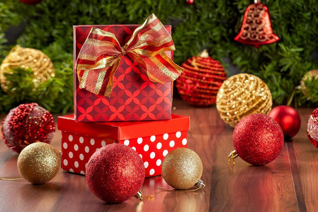 Una caja regalo, acompañada de unas felicitaciones de navidad.