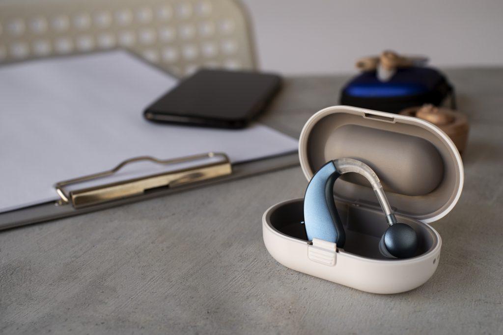 Una imagen de unos auriculares inalámbricos para TV para personas mayores, apoyados en una mesa.